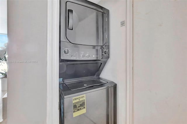 clothes washing area with stacked washer and clothes dryer