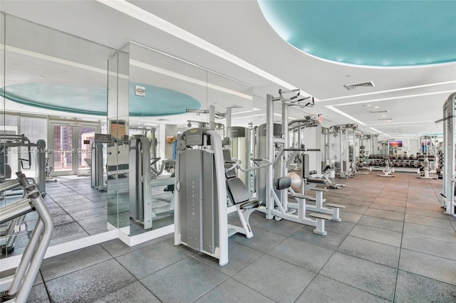 exercise room with a tray ceiling