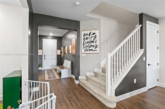 staircase with hardwood / wood-style flooring