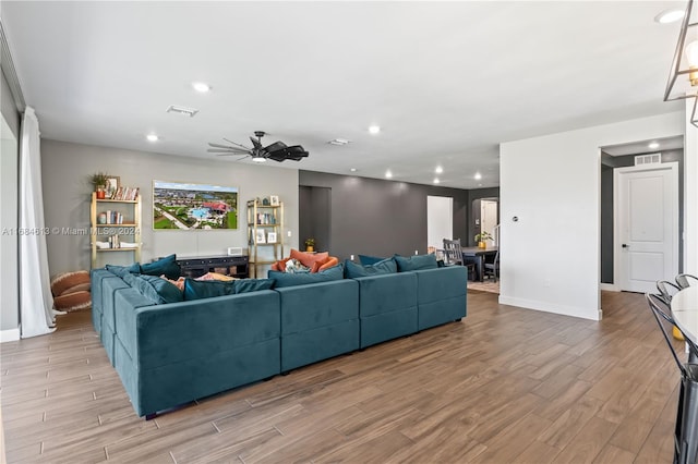 living room with light wood-type flooring and ceiling fan