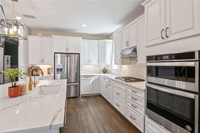 kitchen featuring stainless steel appliances, dark hardwood / wood-style floors, white cabinets, and sink