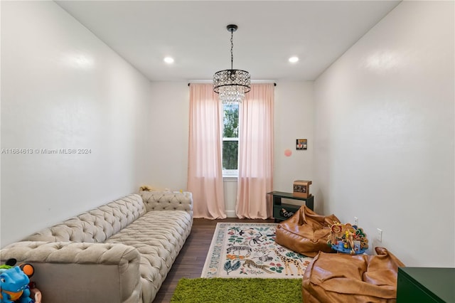 living room with dark wood-type flooring and a chandelier