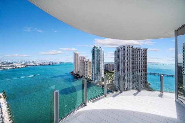 balcony with a water view and central AC