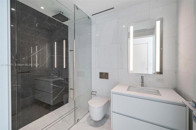 bathroom with tile walls, vanity, a shower with shower door, and toilet