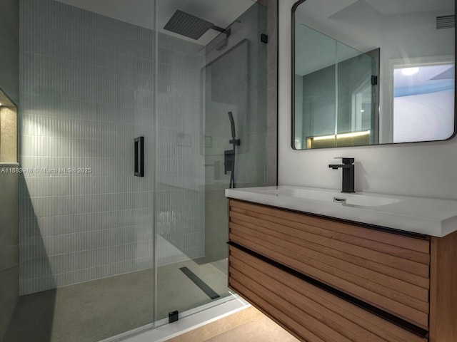 bathroom with a stall shower, visible vents, and vanity