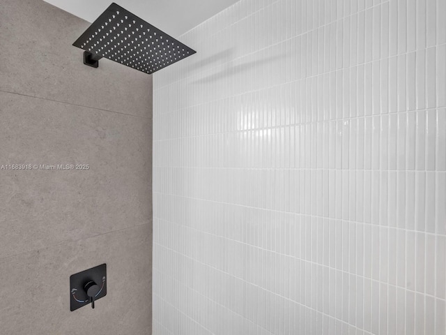 interior details featuring a tile shower