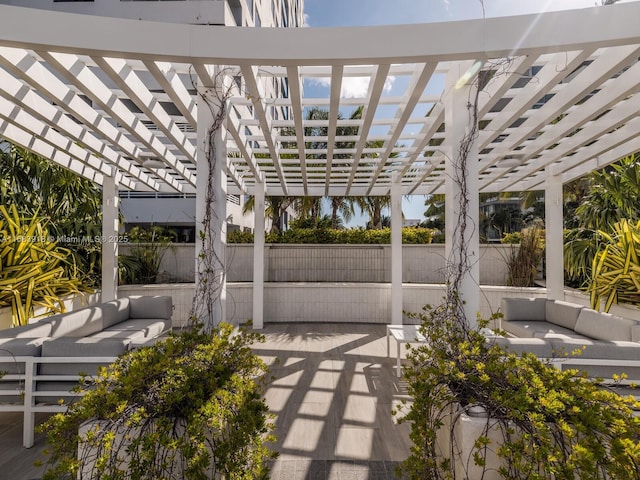 view of patio / terrace with a pergola, an outdoor hangout area, and fence