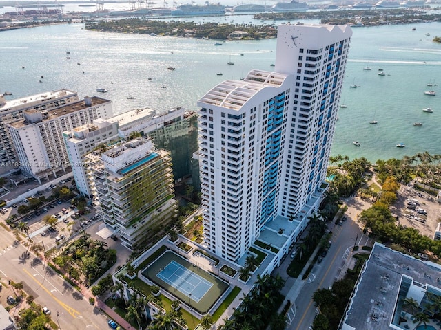drone / aerial view featuring a city view and a water view