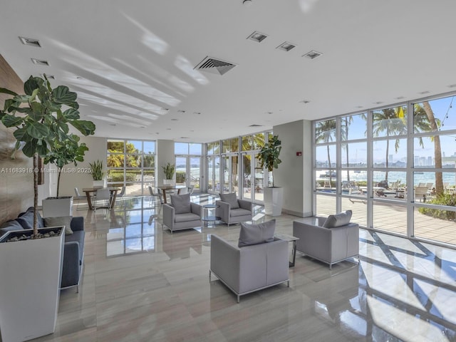 building lobby featuring a water view and visible vents