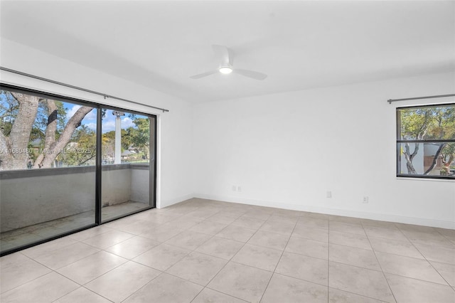 tiled empty room with ceiling fan and a wealth of natural light