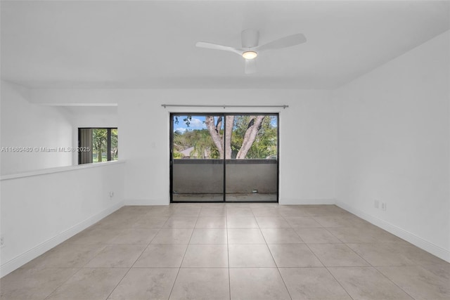 empty room with light tile patterned floors and ceiling fan