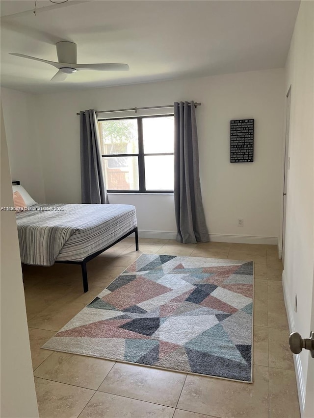 tiled spare room featuring ceiling fan