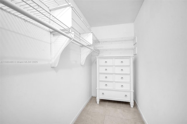 spacious closet with light tile patterned floors