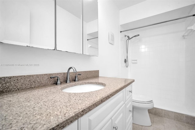 bathroom featuring tile patterned flooring, toilet, vanity, and walk in shower