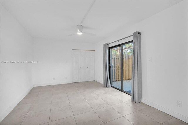 empty room featuring ceiling fan and light tile patterned flooring