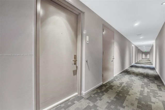 corridor with dark colored carpet