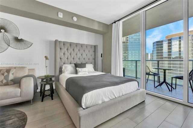 bedroom featuring floor to ceiling windows and access to outside