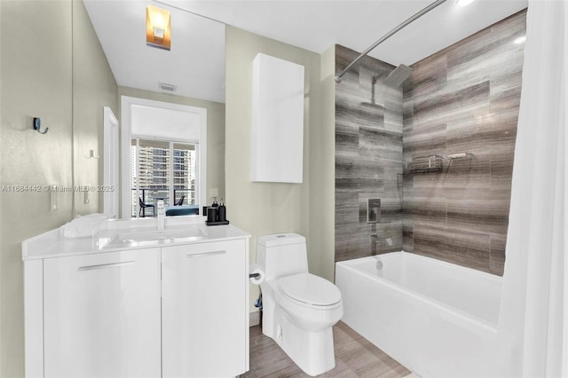 full bathroom with vanity, toilet, and washtub / shower combination