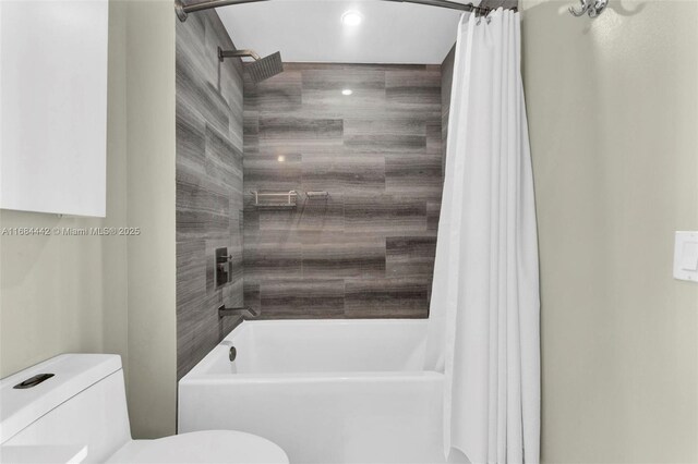 bathroom featuring shower / bathtub combination with curtain and toilet