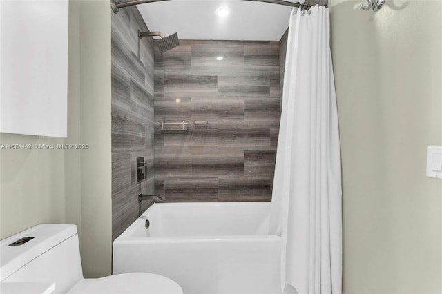 bathroom with shower / bath combination with curtain and toilet