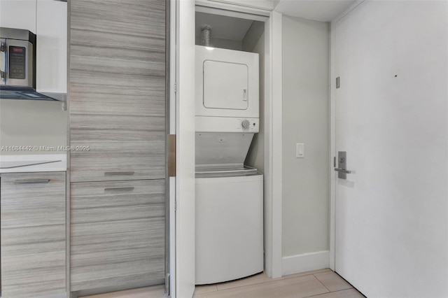 laundry area with stacked washer / dryer