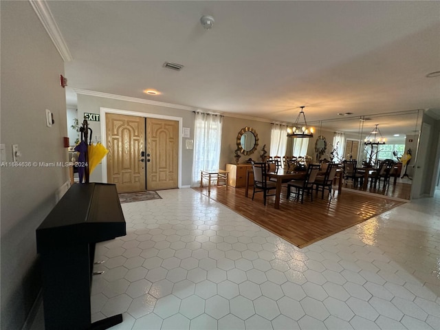 unfurnished dining area featuring crown molding, a chandelier, and tile patterned floors