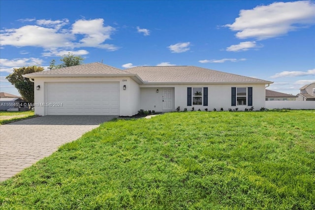 ranch-style house featuring a front lawn and a garage