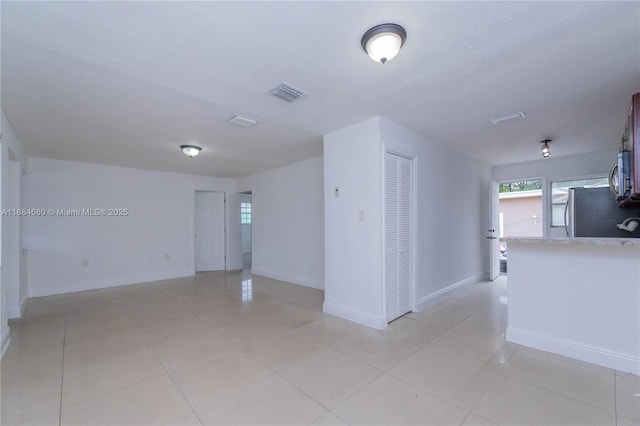 spare room featuring light tile patterned floors