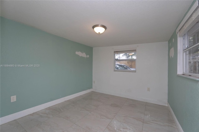 unfurnished room featuring a textured ceiling