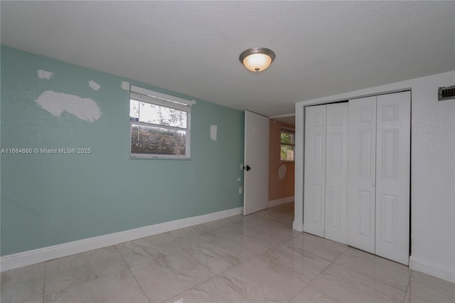 unfurnished bedroom featuring a closet and a textured ceiling