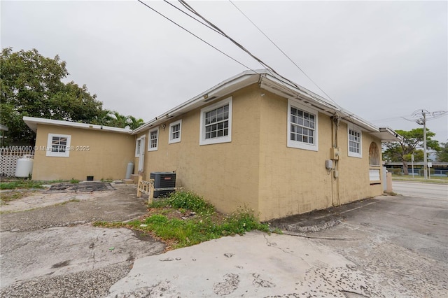 view of property exterior with central AC unit and a patio area