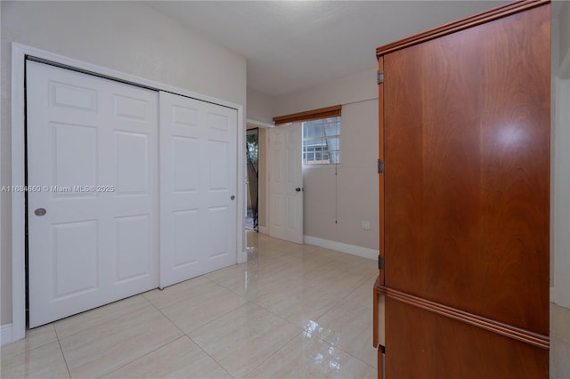 hall with light tile patterned floors