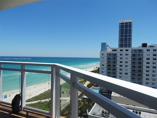 balcony featuring a water view and a view of the beach