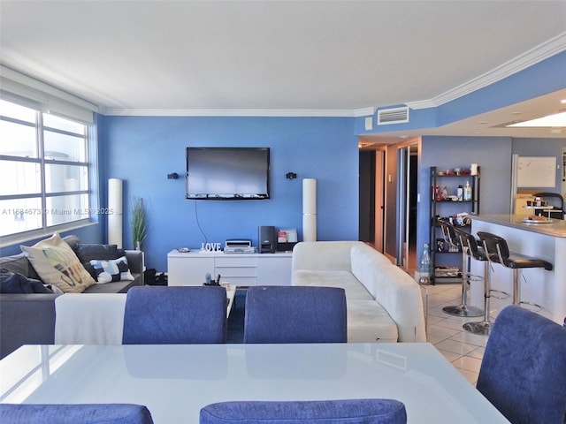 living area featuring ornamental molding, tile patterned flooring, and visible vents