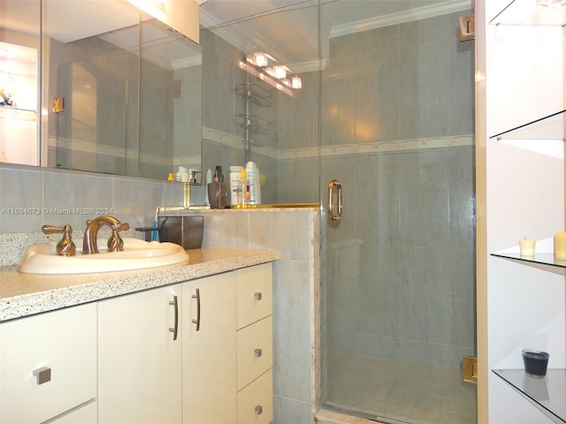 bathroom with decorative backsplash, vanity, crown molding, and a shower with shower door