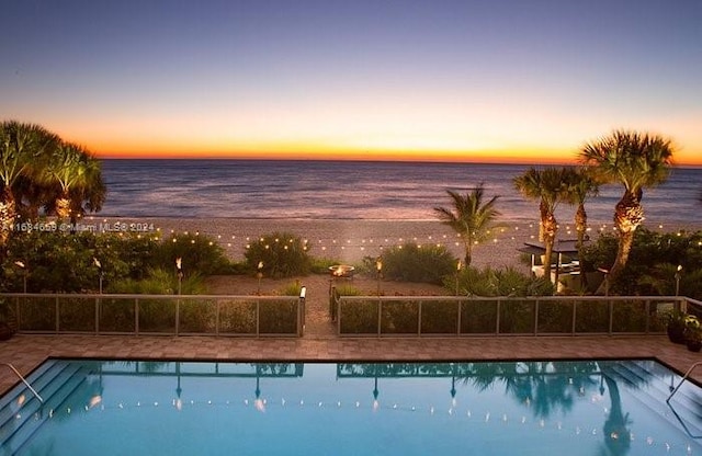 pool at dusk with a water view