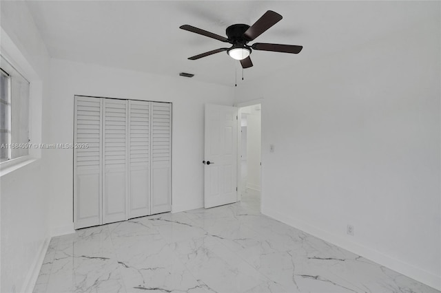 unfurnished bedroom featuring a closet and ceiling fan