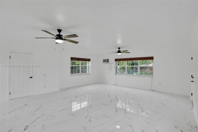 spare room featuring ceiling fan, plenty of natural light, and a wall mounted AC