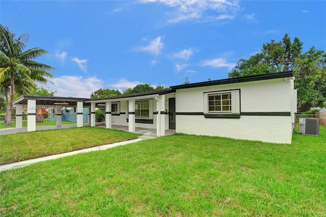 ranch-style house with cooling unit and a front lawn