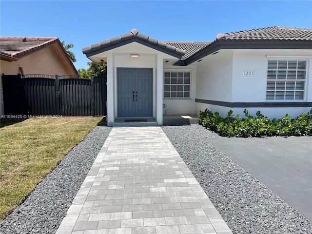 doorway to property with a yard