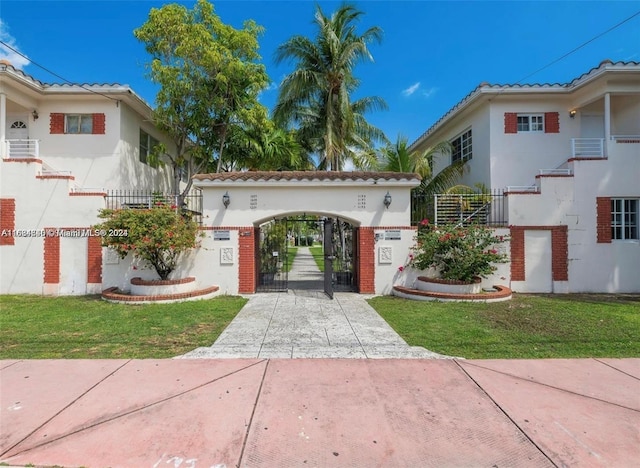 mediterranean / spanish-style home with a front lawn