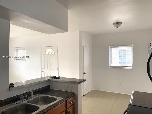 kitchen featuring light tile patterned flooring and sink