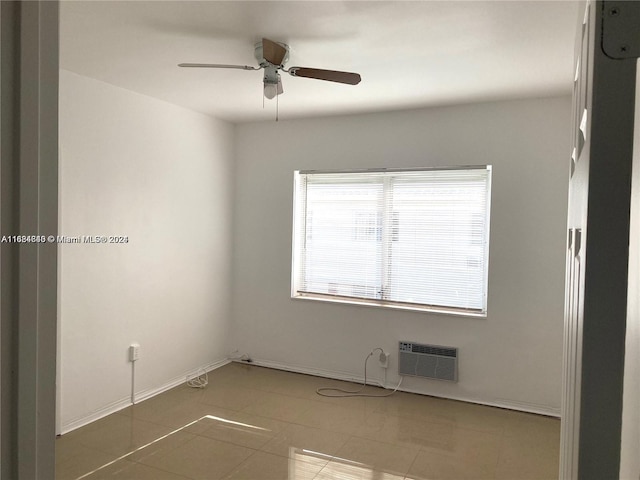 unfurnished room with tile patterned floors, a wall mounted AC, and ceiling fan