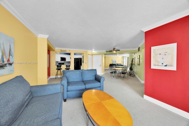 living room featuring crown molding, a textured ceiling, carpet, and ceiling fan