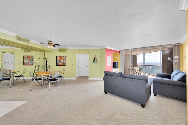 living room with crown molding, a textured ceiling, light colored carpet, and ceiling fan