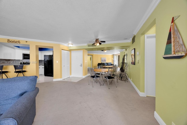 dining area with crown molding, light carpet, and ceiling fan