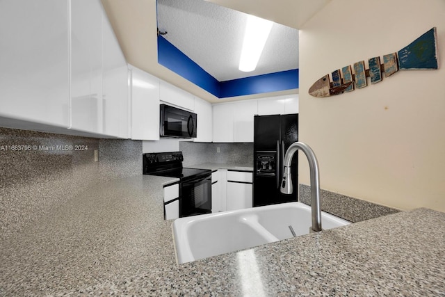 kitchen featuring white cabinets, tasteful backsplash, a textured ceiling, black appliances, and sink