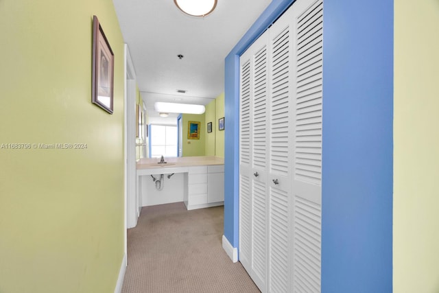 6767 Collins Ave Unit 706, Miami Beach, FL 33141 - hall with light carpet, baseboards, and a desk