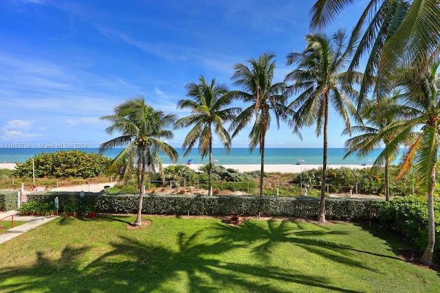 view of property's community with a yard and a water view