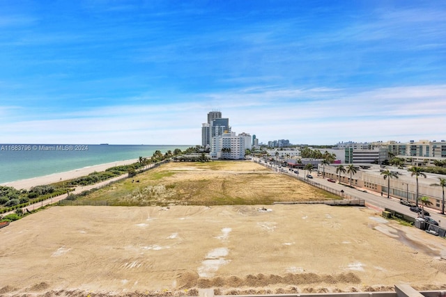 aerial view with a water view and a beach view